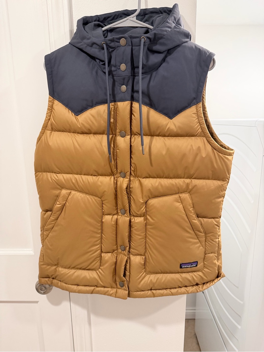 Patagonia Women’s' Two-Tone Puffer Vest in light golden brown and Navy